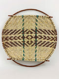front of a woven yucca basket with willow handles on a white background