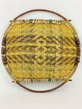 back of a woven yucca basket with willow handles on a white background